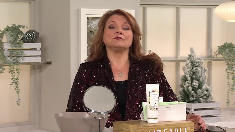 A woman in a sparkly jacket stands in front of a QVC Beauty display. She's talking, and a small mirror and skincare products sit on the table in front of her.
A woman in a sparkly jacket stands in front of a QVC Beauty display. She's talking, and a small mirror and skincare products sit on the table in front of her.