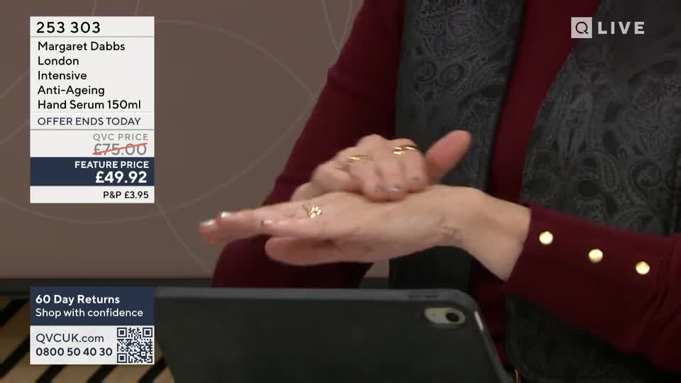 A hand is being massaged with serum, the fingers moving across the skin. The QVC Live logo is visible in the corner.