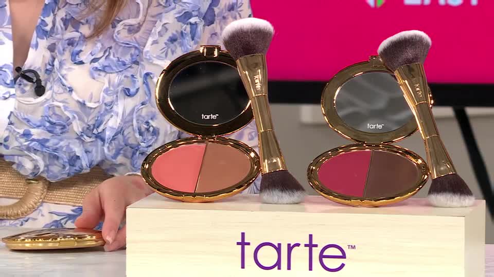 A woman in a floral blouse presents two Tarte compacts, each with a dual-ended brush. One compact holds a rosy blush and a bronzer, while the other displays a deep berry and a rich brown shade.