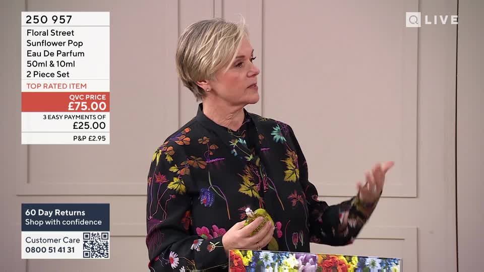 A woman in a floral jacket holds up a small, green bottle, gesturing with her other hand. A screen displays details for "Floral Street Sunflower Pop Eau De Parfum."
