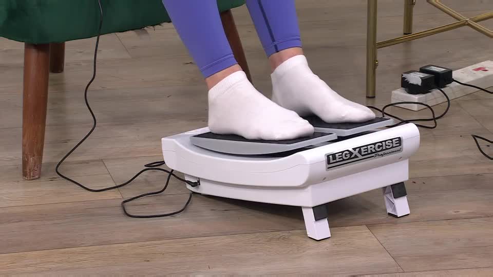 White-socked feet are planted on a vibrating platform, the "LEG XERCISE Professional" logo clearly visible. The device hums, making the feet gently sway back and forth.