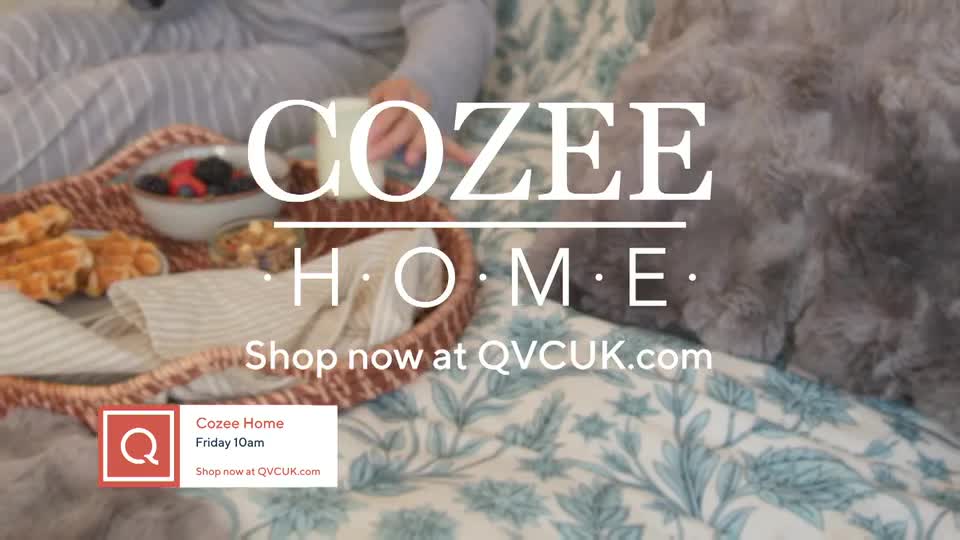A breakfast tray with waffles and berries sits on a bed. The "Cozee Home" logo appears over the scene, with a QVC UK website address below.