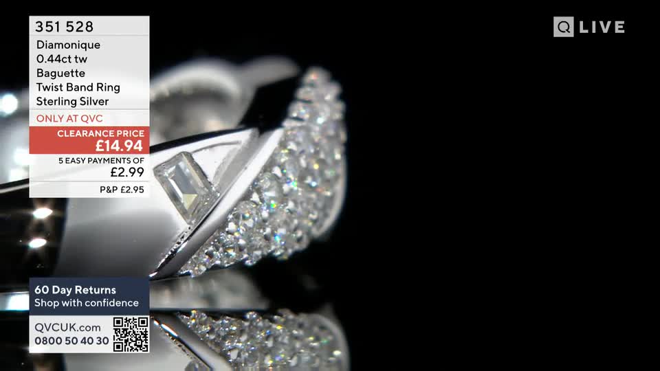 A close-up shows a Diamonique ring, its surface catching the light. The QVC Extra screen displays the price and details of the sterling silver piece.
