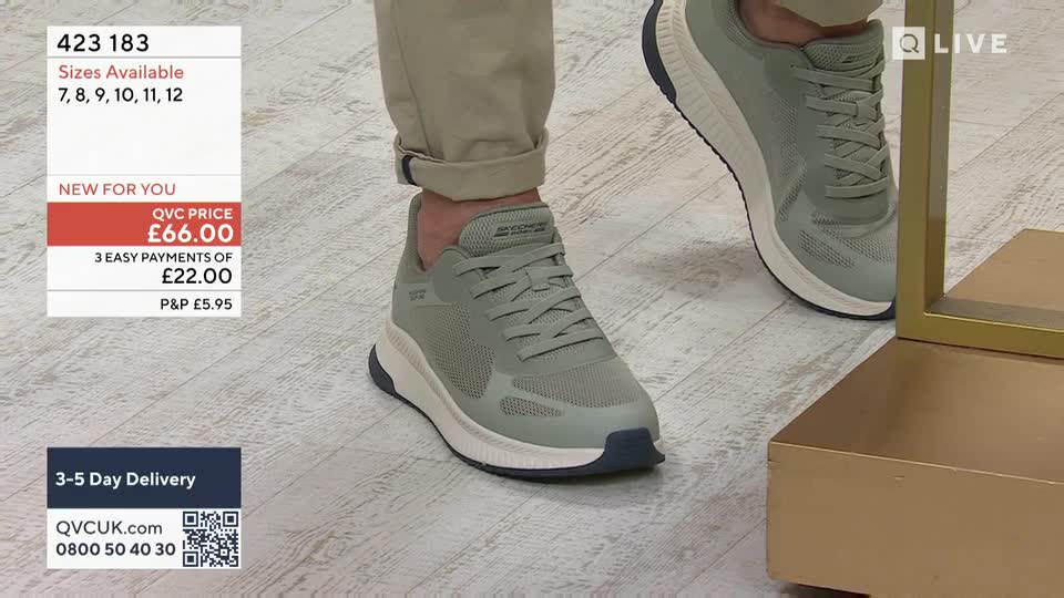 A person is demonstrating a pair of light green trainers with white soles. The trainers are being shown off on a pale wooden floor, with a QVC Extra graphic visible in the corner. A person is demonstrating a pair of light green trainers with white soles. The trainers are being shown off on a pale wooden floor, with a QVC Extra graphic visible in the corner.