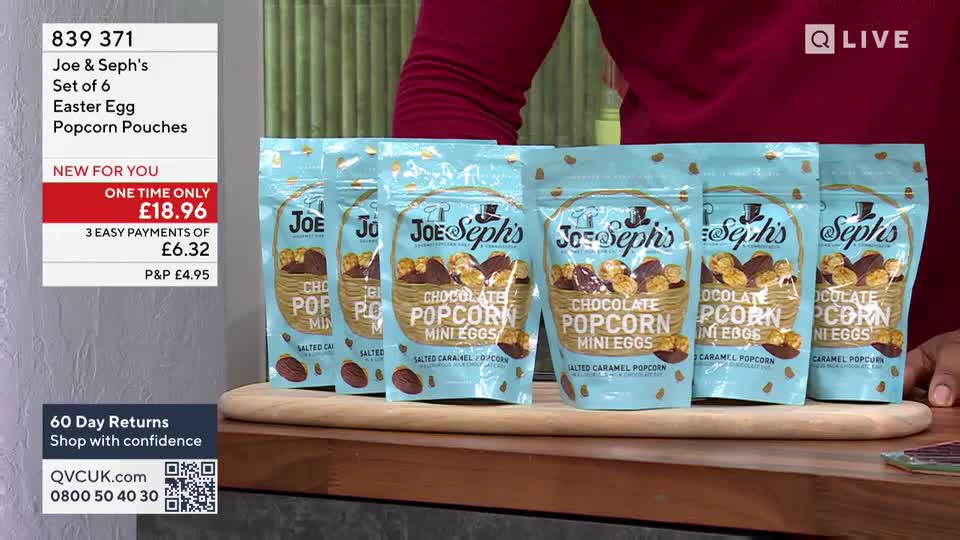 A set of six Joe & Seph's Easter Egg Popcorn Pouches sits on a wooden board. The bags are light blue with a gold polka dot pattern and feature an illustration of a basket overflowing with chocolate popcorn.