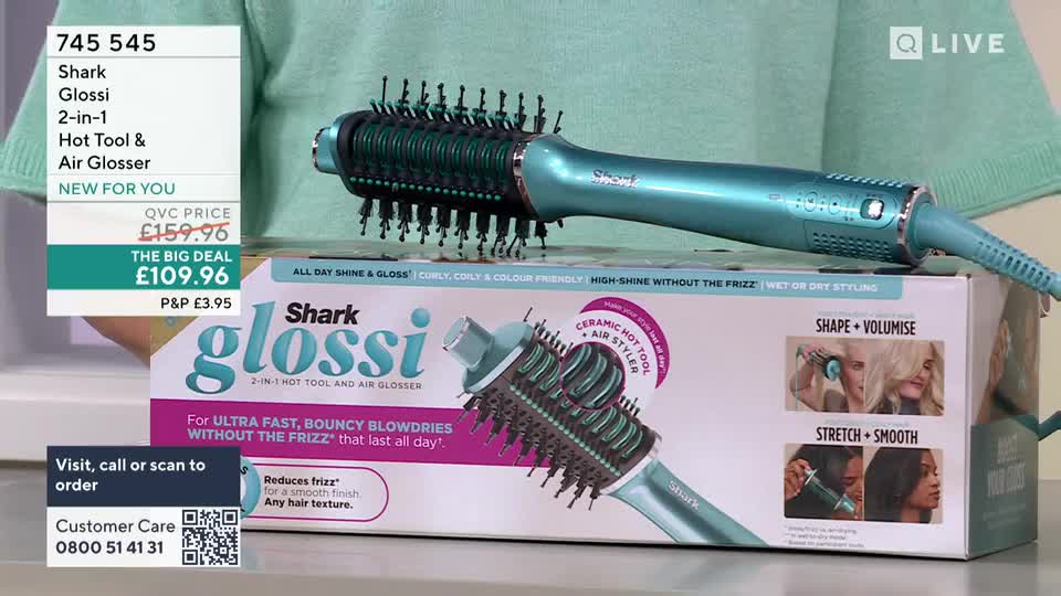 A teal Shark Glossi hot tool rests on its branded box. The box displays images of women styling their hair with the device.