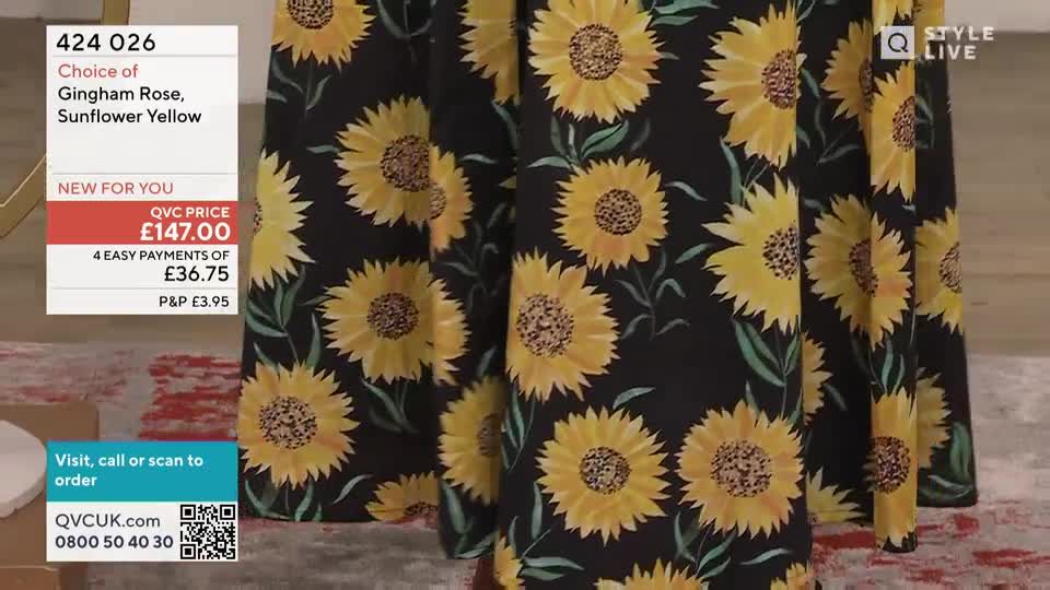 A patterned skirt, covered in large sunflowers on a black background, hangs on display. The QVC price and payment options are clearly visible in the corner, offering a glimpse into the product's cost.
