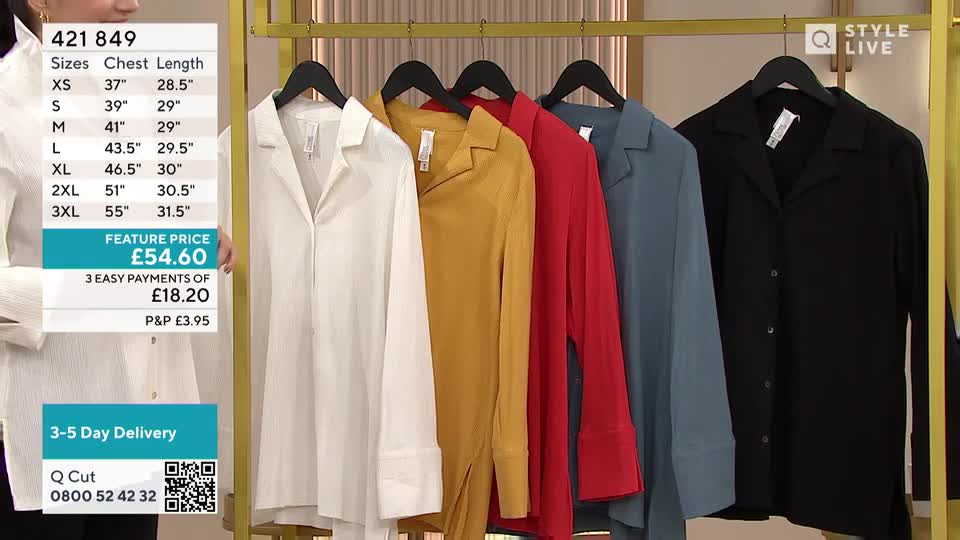 A rack of button-down shirts in various colors hangs in a studio, each garment displayed in front of a screen showing the price and size details. The presenter stands to the left, presumably ready to discuss the items on offer.
