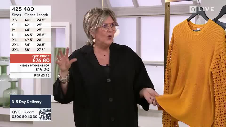 A woman gestures animatedly while holding up a bright yellow, open-knit sweater. A screen displays product details and pricing for the garment.