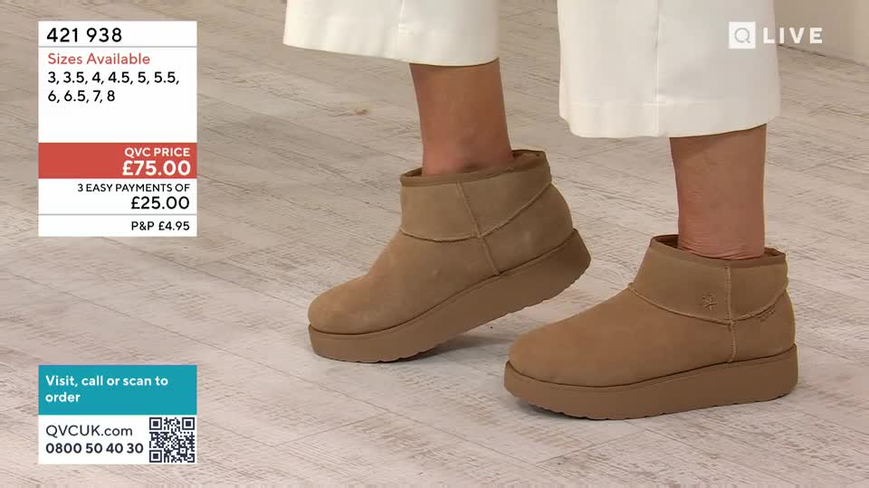 A person is demonstrating tan, ankle-high boots with thick soles on a light wood floor. The boots look comfortable and practical for everyday wear.