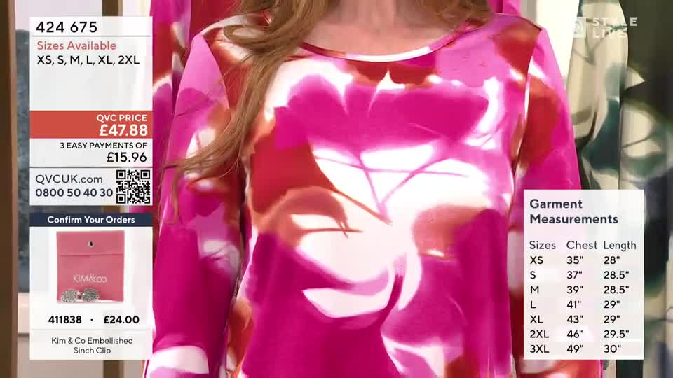 A woman stands in a vibrant pink and white floral top, the fabric flowing as she moves. On the screen, details about garment sizes and prices are displayed, alongside a small pink box with a silver brooch.