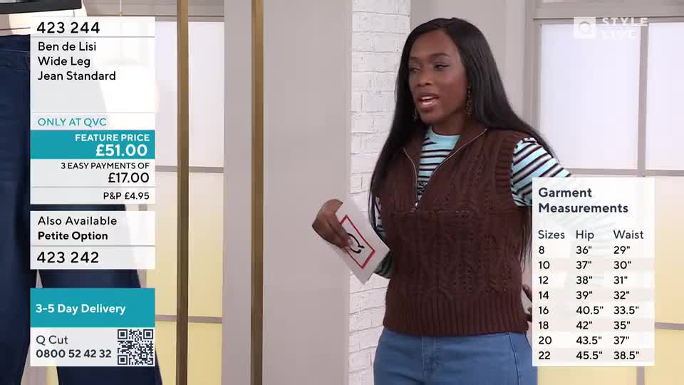 A woman stands in front of a screen displaying product details for "Ben de Lisi Wide Leg Jean Standard." She holds a card with a red and white graphic as a measurement chart for garment sizes is displayed to her right.