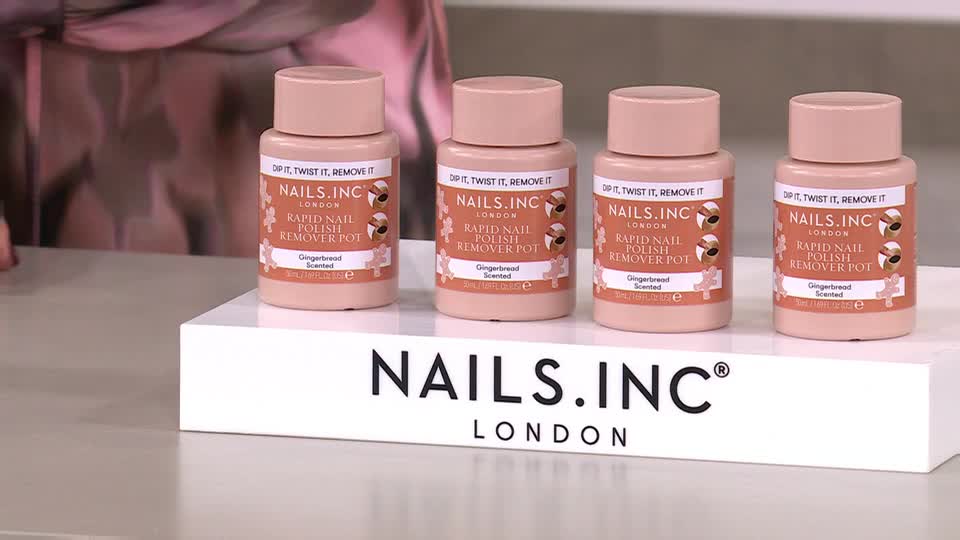 Four bottles of nail polish remover sit on a white platform, each with a pale pink hue and a matching cap. The "NAILS.INC LONDON" logo is prominently displayed below them, likely part of a QVC segment.
Four bottles of nail polish remover sit on a white platform, each with a pale pink hue and a matching cap. The "NAILS.INC LONDON" logo is prominently displayed below them, likely part of a QVC segment.