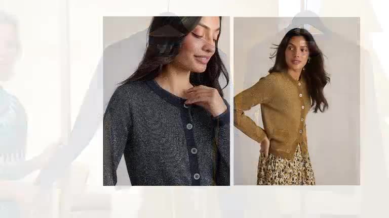 A woman models two different cardigans, one dark and one gold, on what looks like a QVC set. She's smiling, her hands casually placed as she shows off the outfits.
