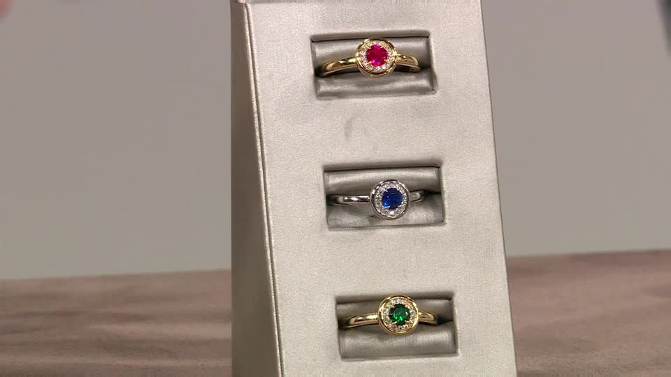 Three rings sit in individual slots, each with a different colored gemstone at the center. The rings are arranged on a display, likely for a QVC presentation in the United Kingdom.
Three rings sit in individual slots, each with a different colored gemstone at the center. The rings are arranged on a display, likely for a QVC presentation in the United Kingdom.
