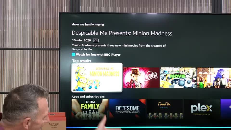 The television displays a menu for "Despicable Me Presents: Minion Madness," available for free on BBC iPlayer. Below that, a row of movie posters shows "Wonka," "Shaun the Sheep Movie," and other family-friendly titles. The television displays a menu for "Despicable Me Presents: Minion Madness," available for free on BBC iPlayer. Below that, a row of movie posters shows "Wonka," "Shaun the Sheep Movie," and other family-friendly titles.