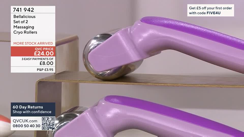 A set of two Bellalicious Cryo Rollers, priced at £24.00 on QVC, are displayed. The purple and silver rollers sit on a light-coloured shelf, with another roller visible below.