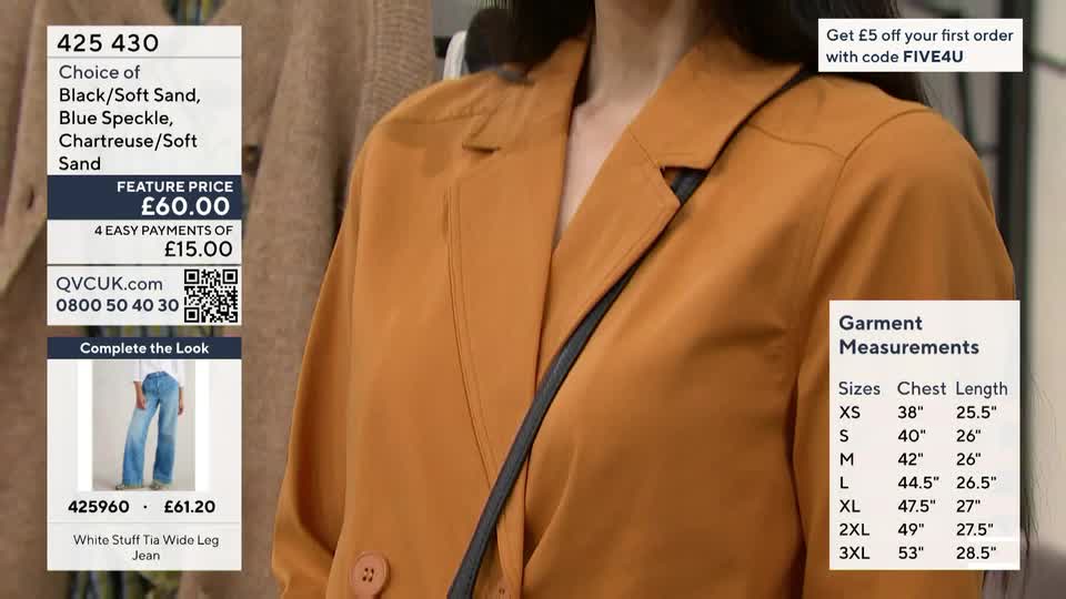 A woman models a rust-coloured blazer, a QVC presenter likely discussing its features. The screen displays product details and garment measurements.