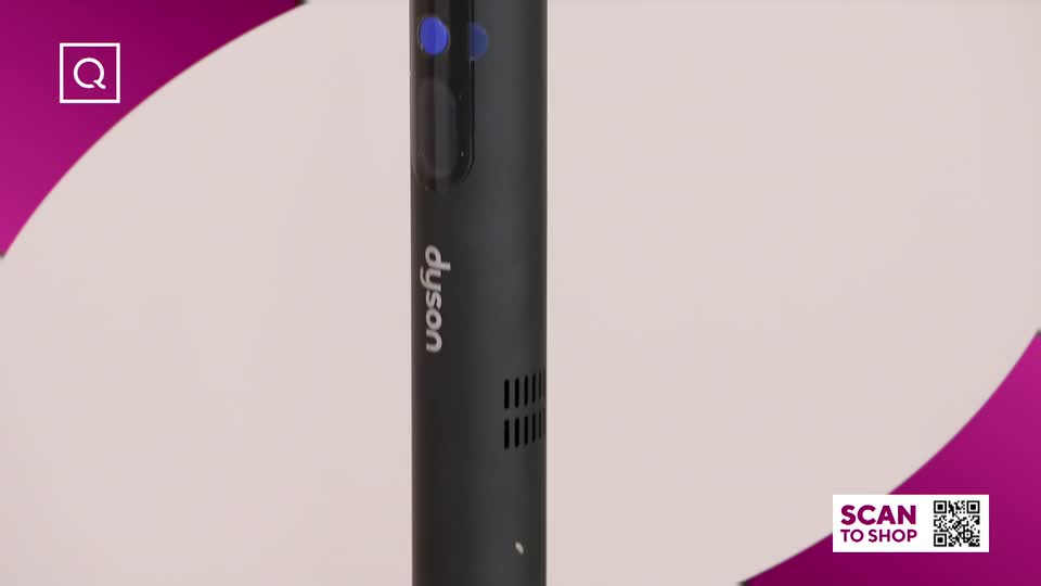 A sleek, black Dyson vacuum stands upright, its logo clearly visible. A QVC graphic with a QR code appears in the corner, inviting shoppers to buy.
