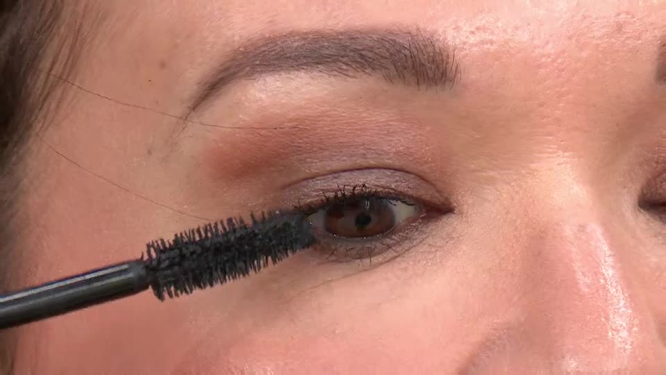 The mascara wand sweeps upwards, darkening lashes.  This is happening live on QVC, right here in the UK.