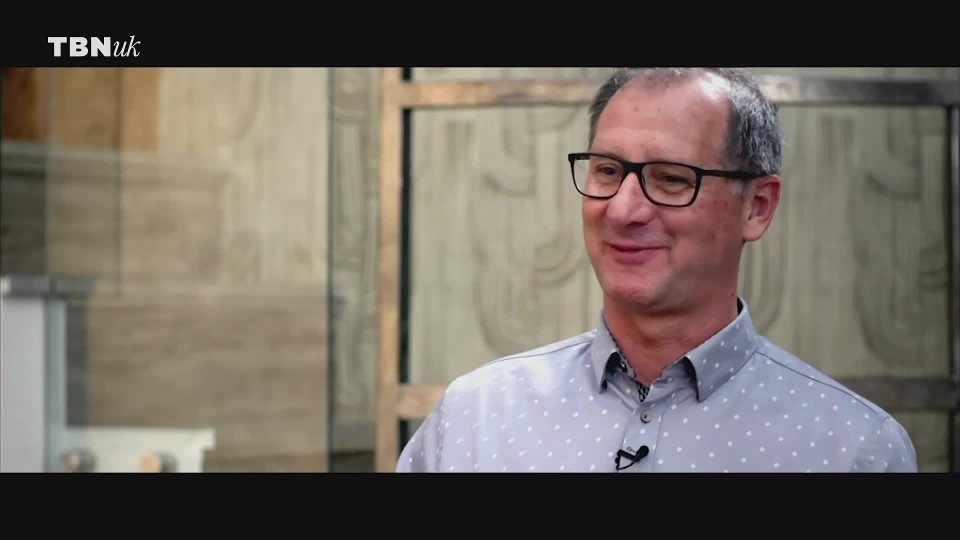 A man with glasses smiles, looking directly at someone off-camera. The TBN UK logo is visible in the corner of the screen.
A man with glasses smiles, looking directly at someone off-camera. The TBN UK logo is visible in the corner of the screen.
