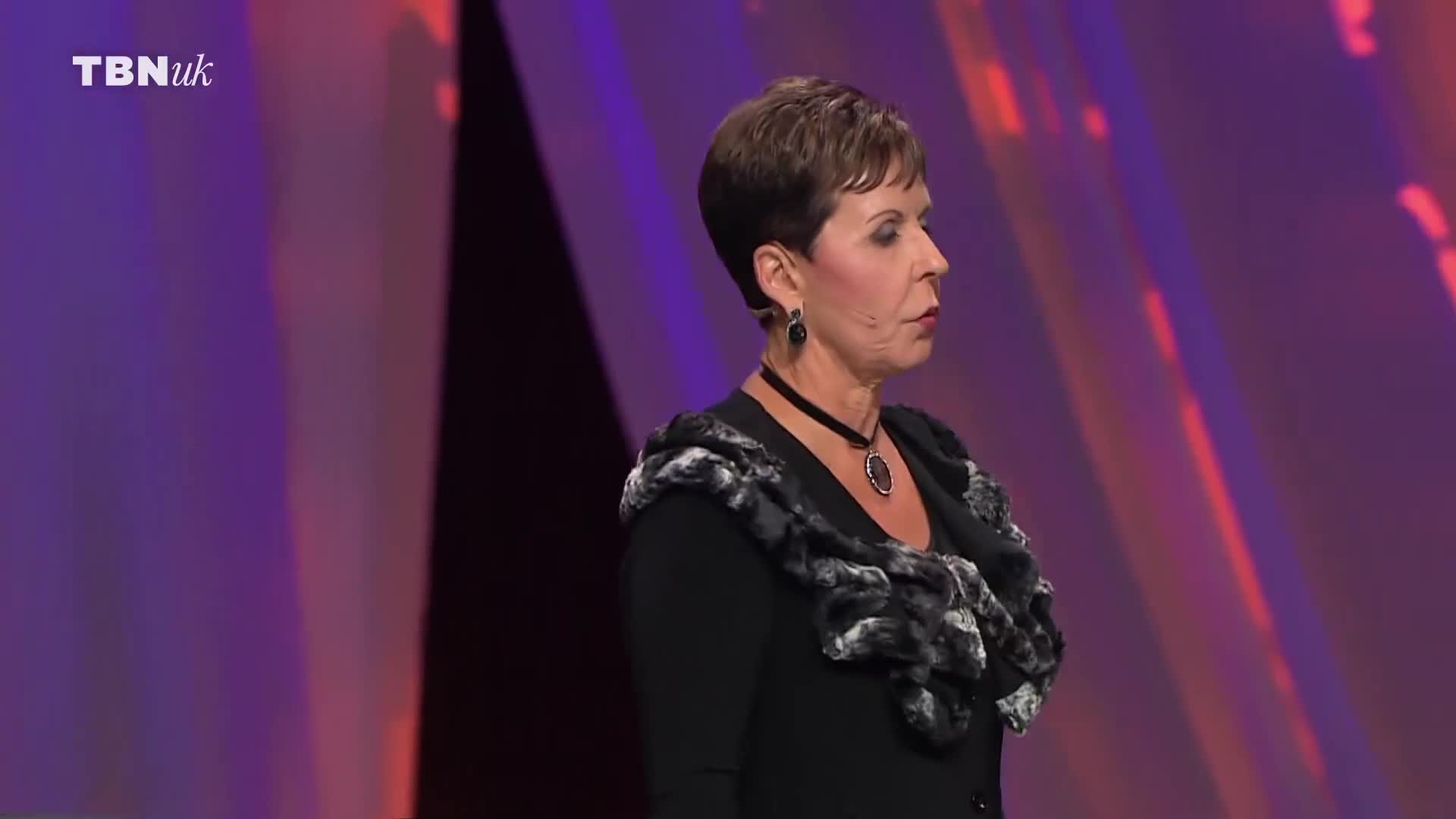 A woman stands on a stage, her face turned to the side. The TBN UK logo is visible in the upper left corner. A woman stands on a stage, her face turned to the side. The TBN UK logo is visible in the upper left corner.