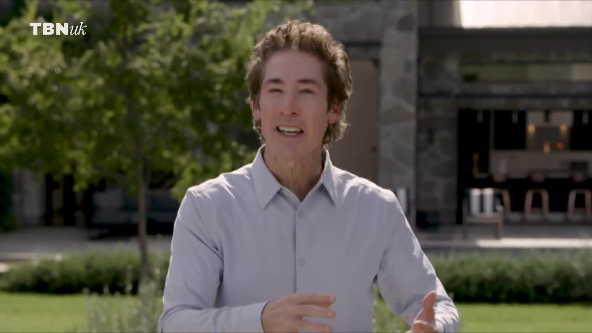 A man in a light blue shirt gestures with his hands as he speaks. The TBN UK logo appears in the top left corner.