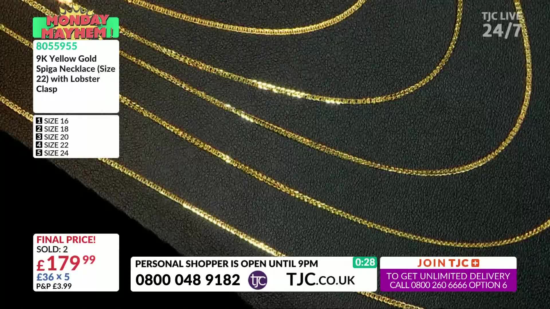 Several gold necklaces are displayed on a dark surface, catching the light.  A graphic on the screen advertises a "Monday Mayhem" sale on the TJC channel, showcasing the jewelry.
