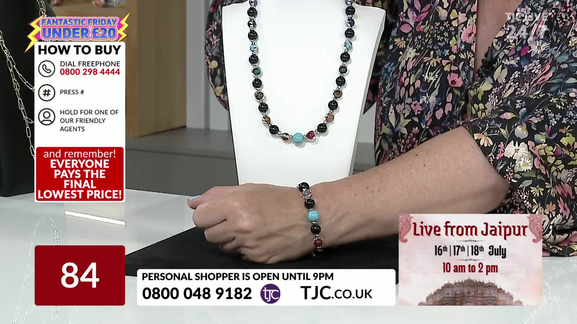 A woman's hand rests on a table, displaying a beaded necklace and bracelet. The TJC logo is visible, and the screen advertises a "Fantastic Friday" sale with items under £20.
