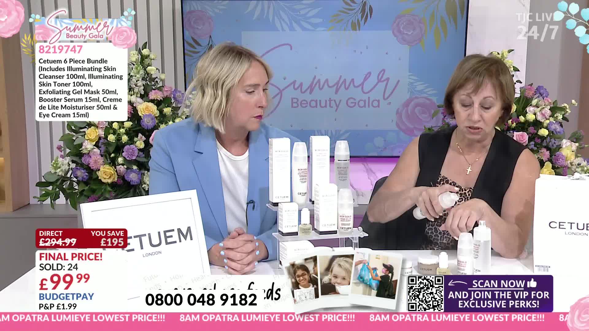 A woman in a black top is demonstrating a product, squeezing it onto her hand. Her colleague, in a blue blazer, looks on as they broadcast live from the United Kingdom on TJC.
