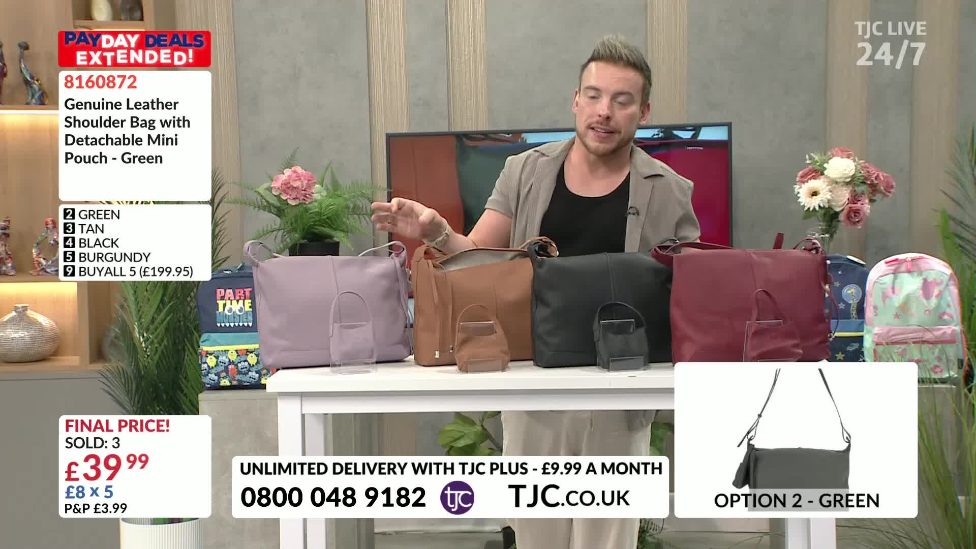 A man in a light jacket gestures towards a row of leather shoulder bags, each with a matching mini pouch. The bags, in various colors, are displayed on a white table, likely for a TJC shopping segment.
