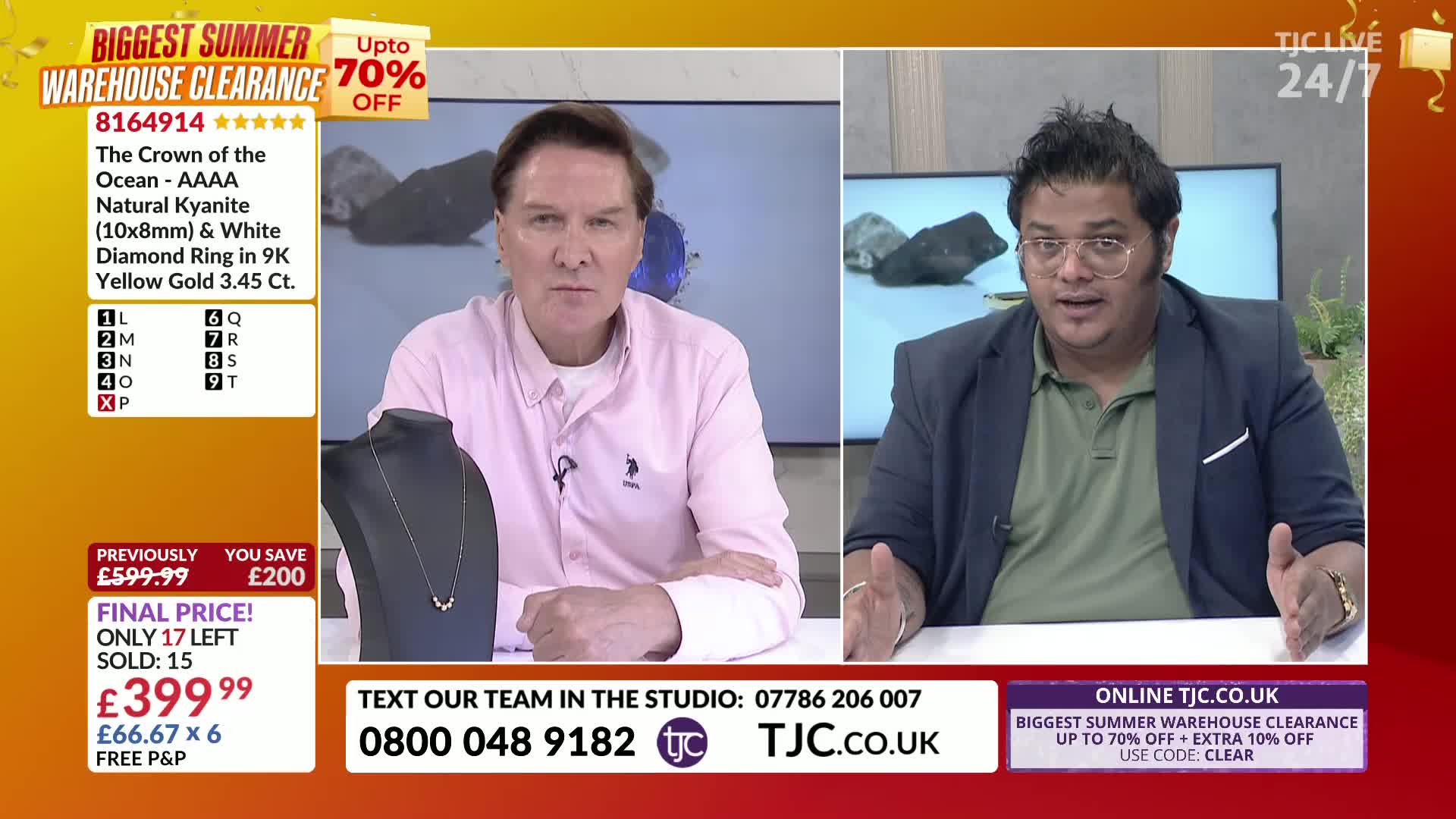 Two men are on the set of a TJC UK show, one in a pink shirt and the other in a blazer, both gesturing with their hands. A necklace is displayed on a stand, and the price is flashing on screen.
