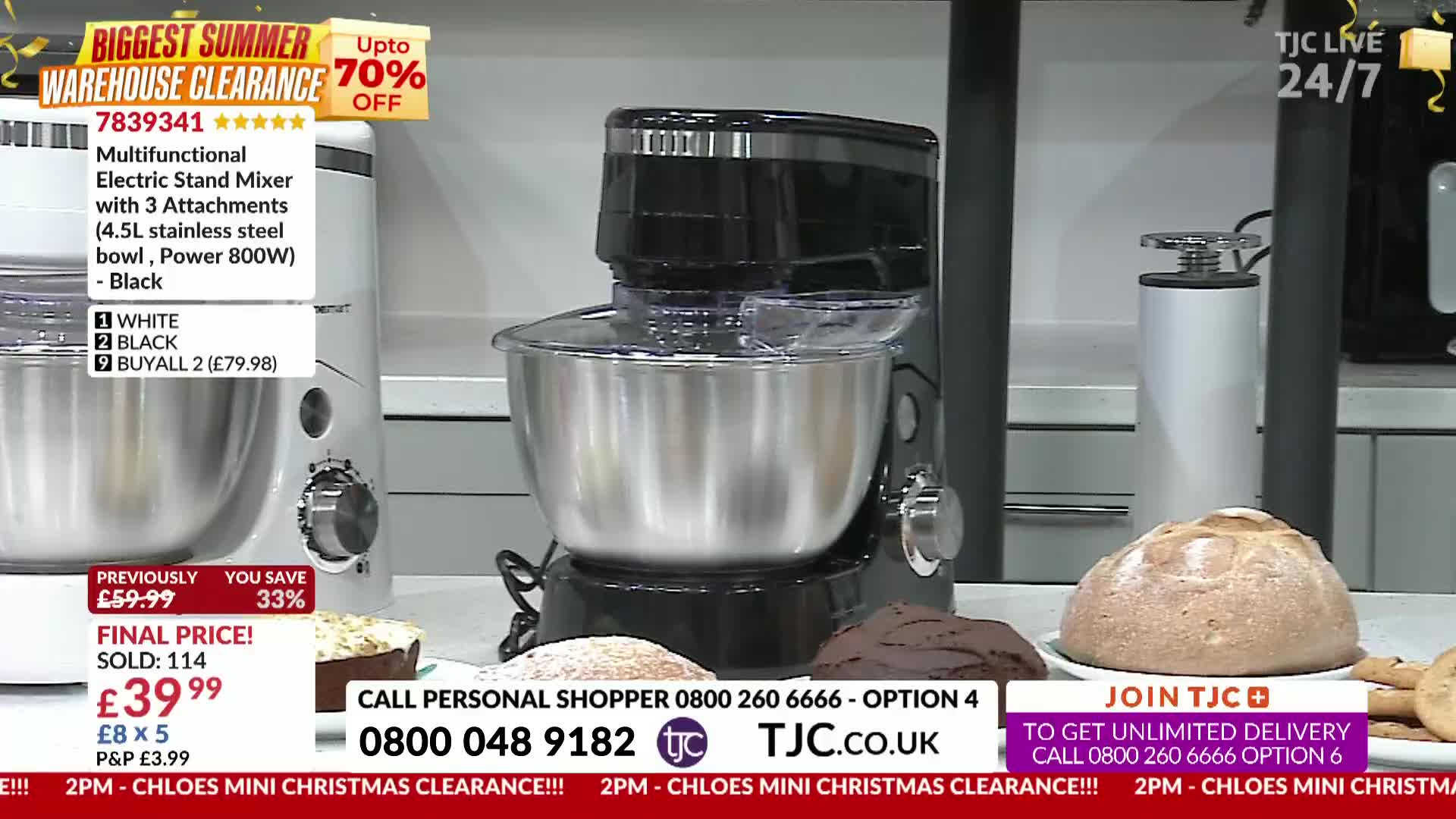 A black stand mixer sits center stage, next to a loaf of bread and some baked goods, all on a table. The TJC logo and a phone number are displayed at the bottom of the screen.
