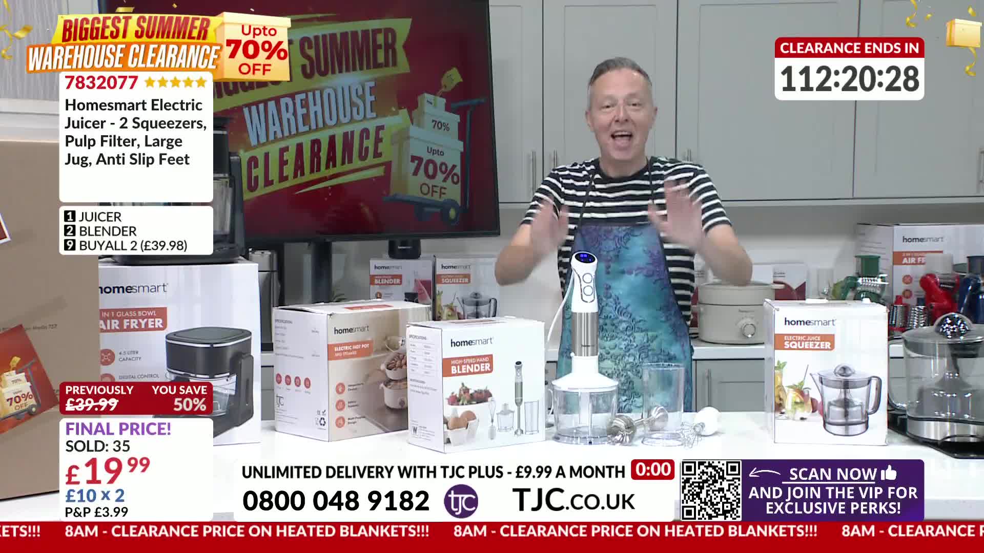 A man in a striped shirt gestures enthusiastically, surrounded by boxed kitchen appliances. The screen behind him advertises a "Biggest Summer Warehouse Clearance" sale on TJC, with a countdown clock ticking down.
