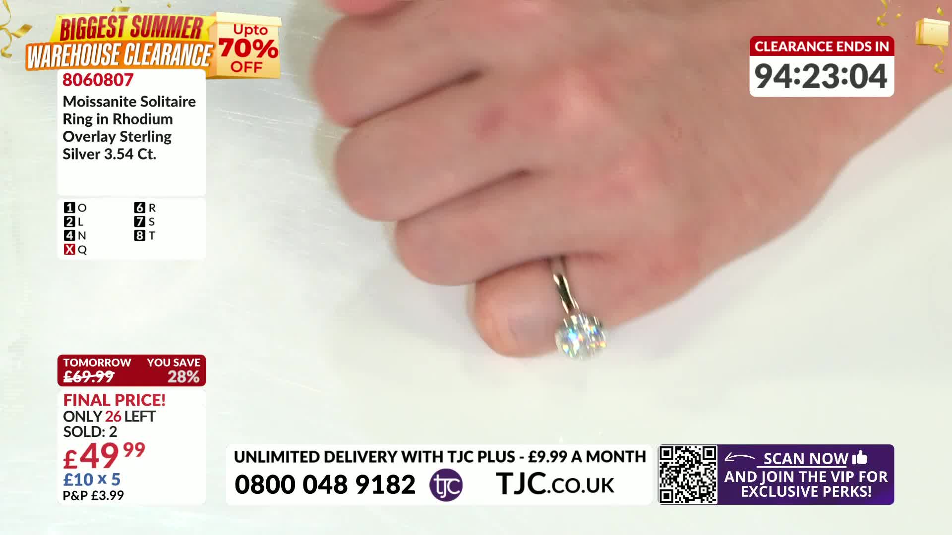 A hand turns, showing off a sparkly ring. The bright stone catches the light, and the countdown clock ticks down on the screen.
