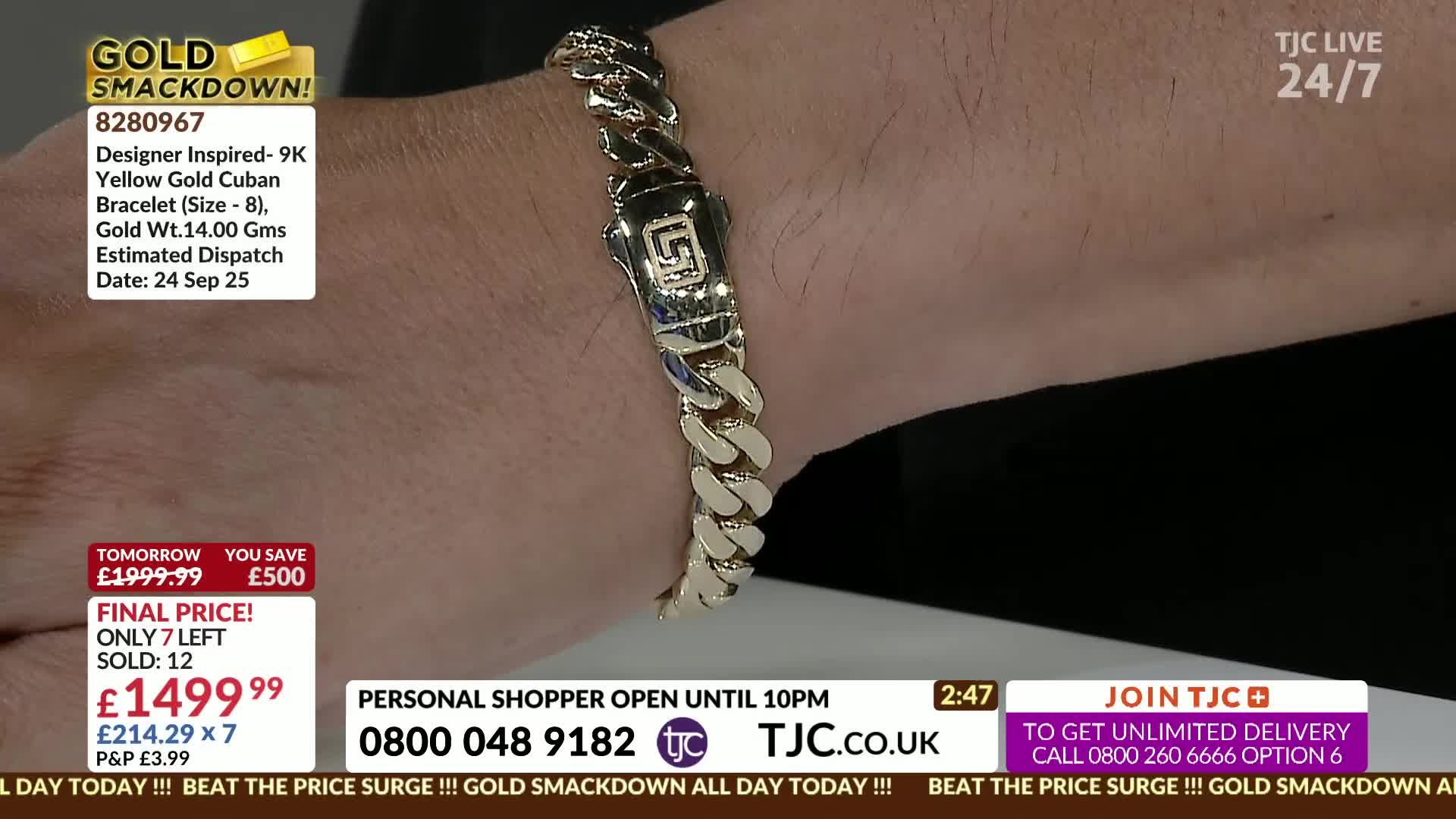 A thick, gold bracelet is fastened around a wrist, catching the light. The TJC screen displays the price and details of the jewelry.
