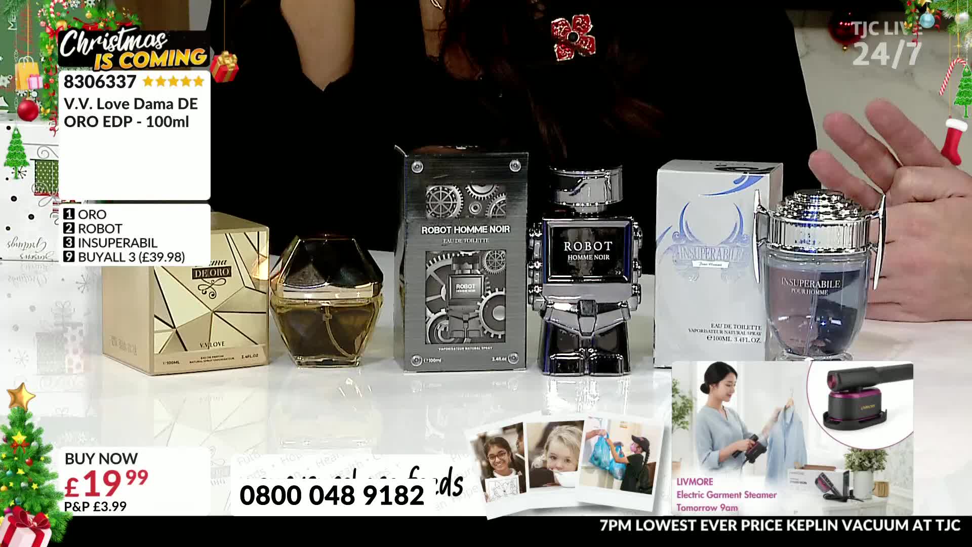 Several perfume bottles sit on a white surface, with a person's hands and a Christmas tree visible in the background. A "TJC" logo is in the top right corner, and the screen displays a "buy now" offer for a perfume.
Several perfume bottles sit on a white surface, with a person's hands and a Christmas tree visible in the background. A "TJC" logo is in the top right corner, and the screen displays a "buy now" offer for a perfume.