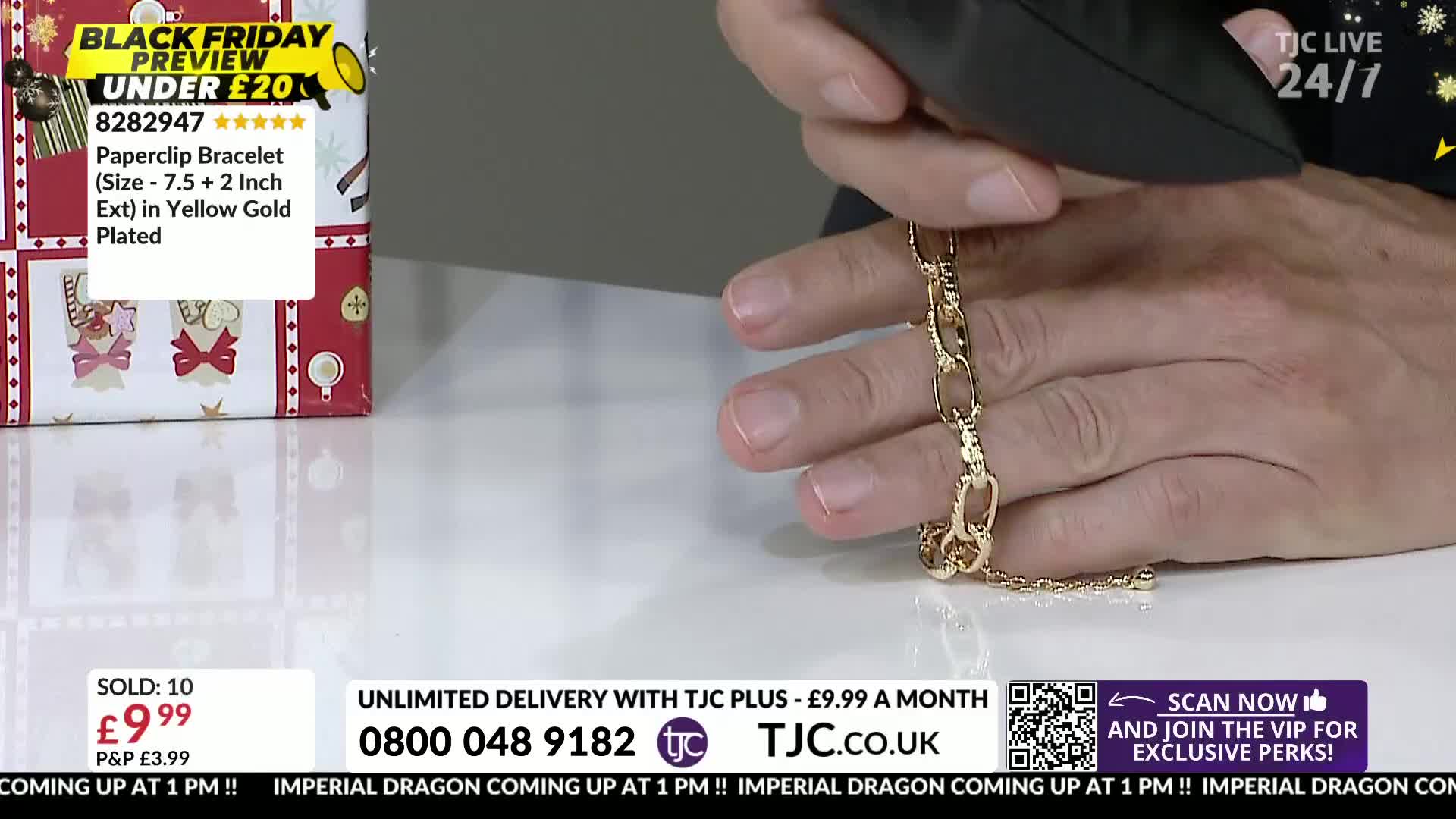 A gold-colored paperclip bracelet is being held up for the camera. The presenter is showing off the jewelry on a TJC live show.
A gold-colored paperclip bracelet is being held up for the camera. The presenter is showing off the jewelry on a TJC live show.
