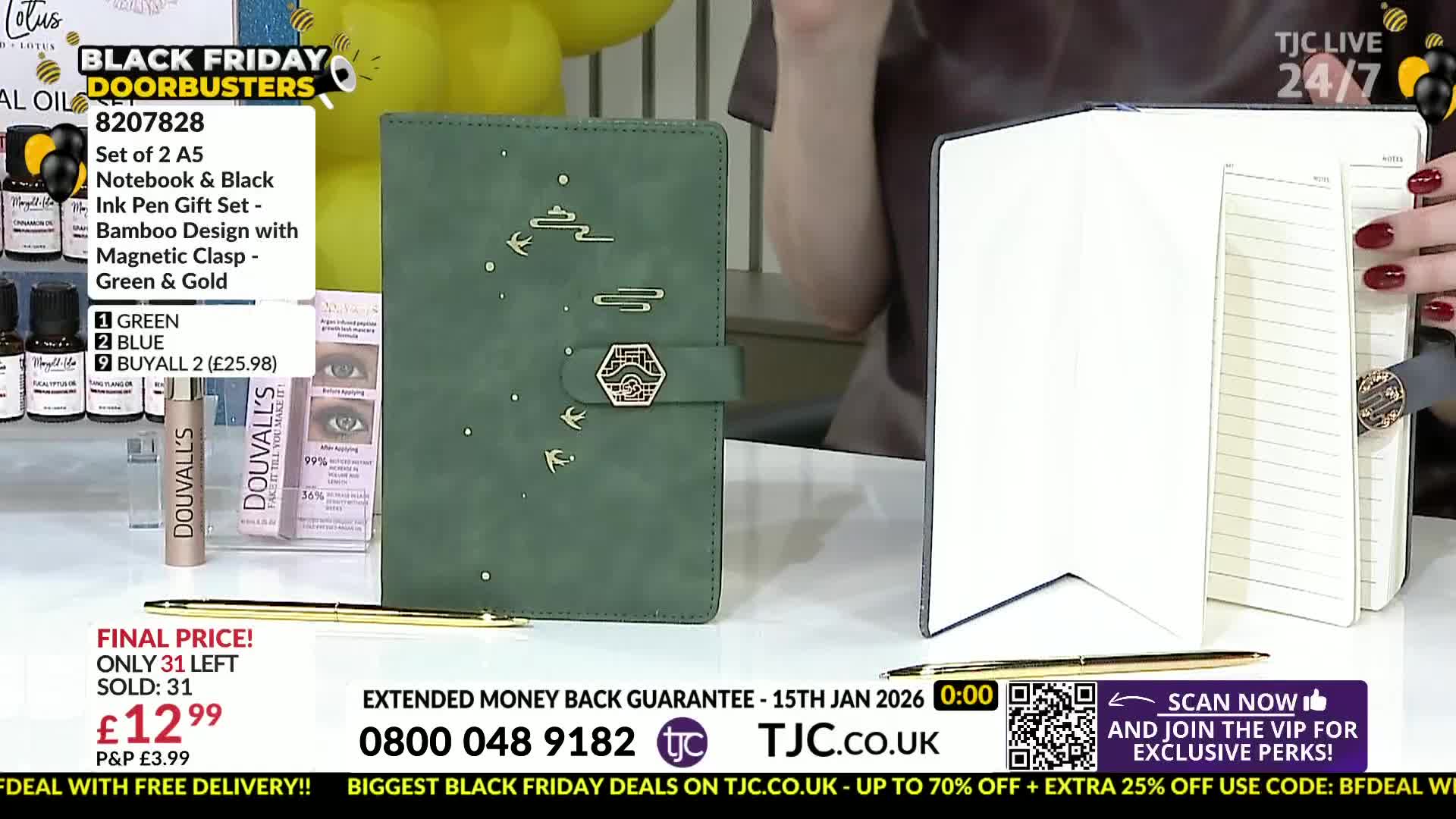 A green notebook with gold accents and a matching pen lie on a table, next to an open notebook. The presenter holds the open notebook, showing off the lined pages.
A green notebook with gold accents and a matching pen lie on a table, next to an open notebook. The presenter holds the open notebook, showing off the lined pages.