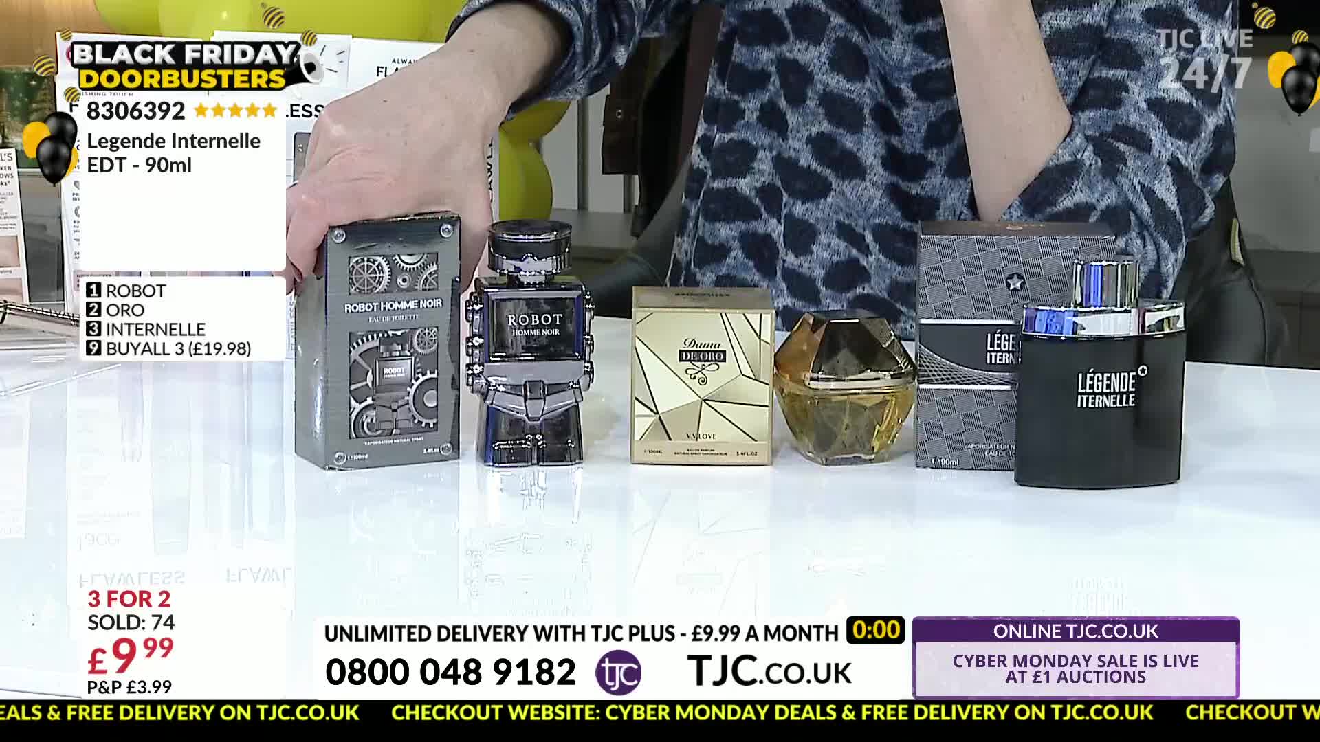 A hand is displaying several bottles of perfume, including one shaped like a robot. The TJC logo is visible, and the screen advertises a Black Friday sale.
A hand is displaying several bottles of perfume, including one shaped like a robot. The TJC logo is visible, and the screen advertises a Black Friday sale.