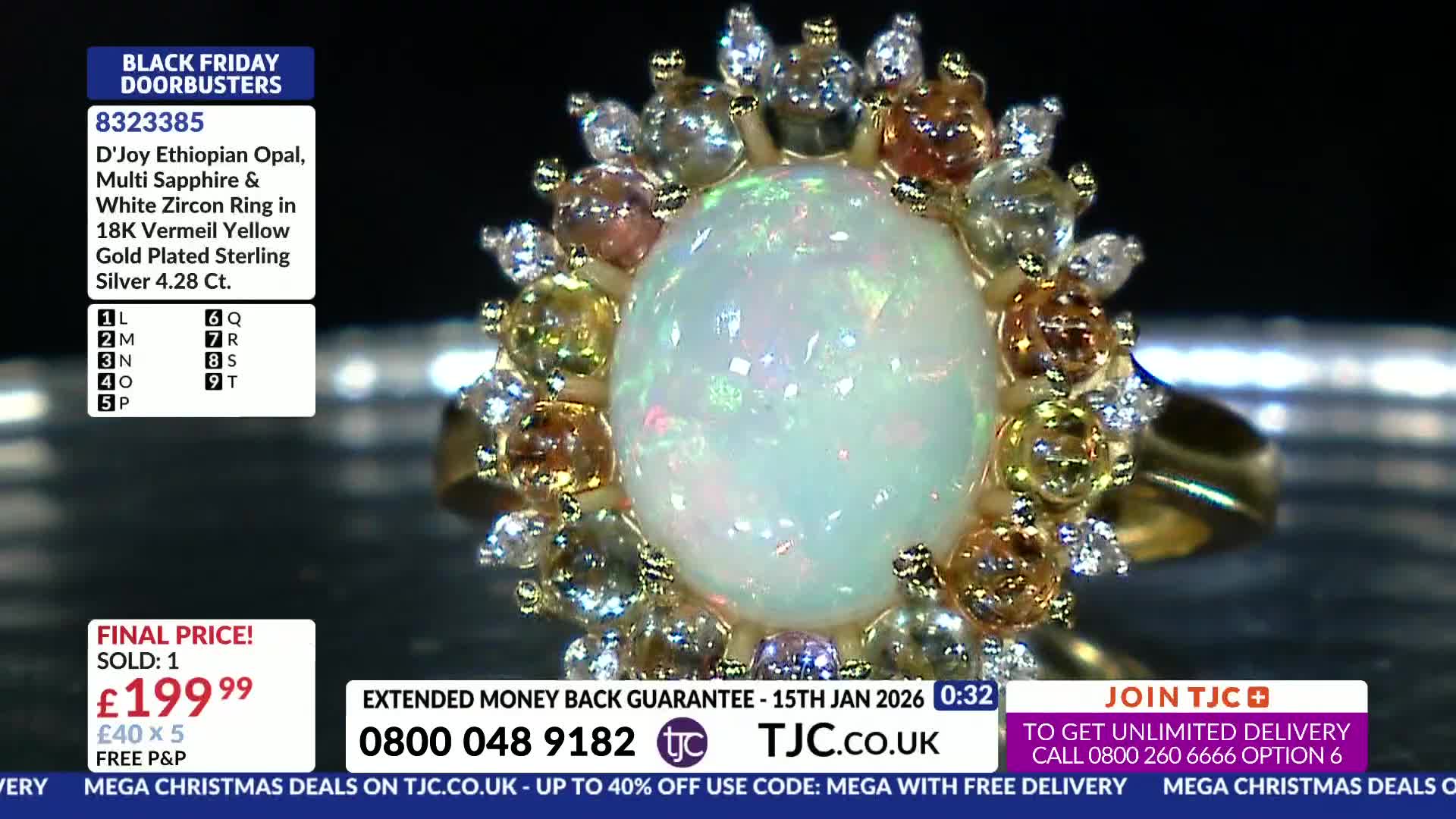 A close-up of a ring with a large, iridescent opal is displayed on the screen. The TJC logo and a phone number are visible at the bottom of the screen.
A close-up of a ring with a large, iridescent opal is displayed on the screen. The TJC logo and a phone number are visible at the bottom of the screen.