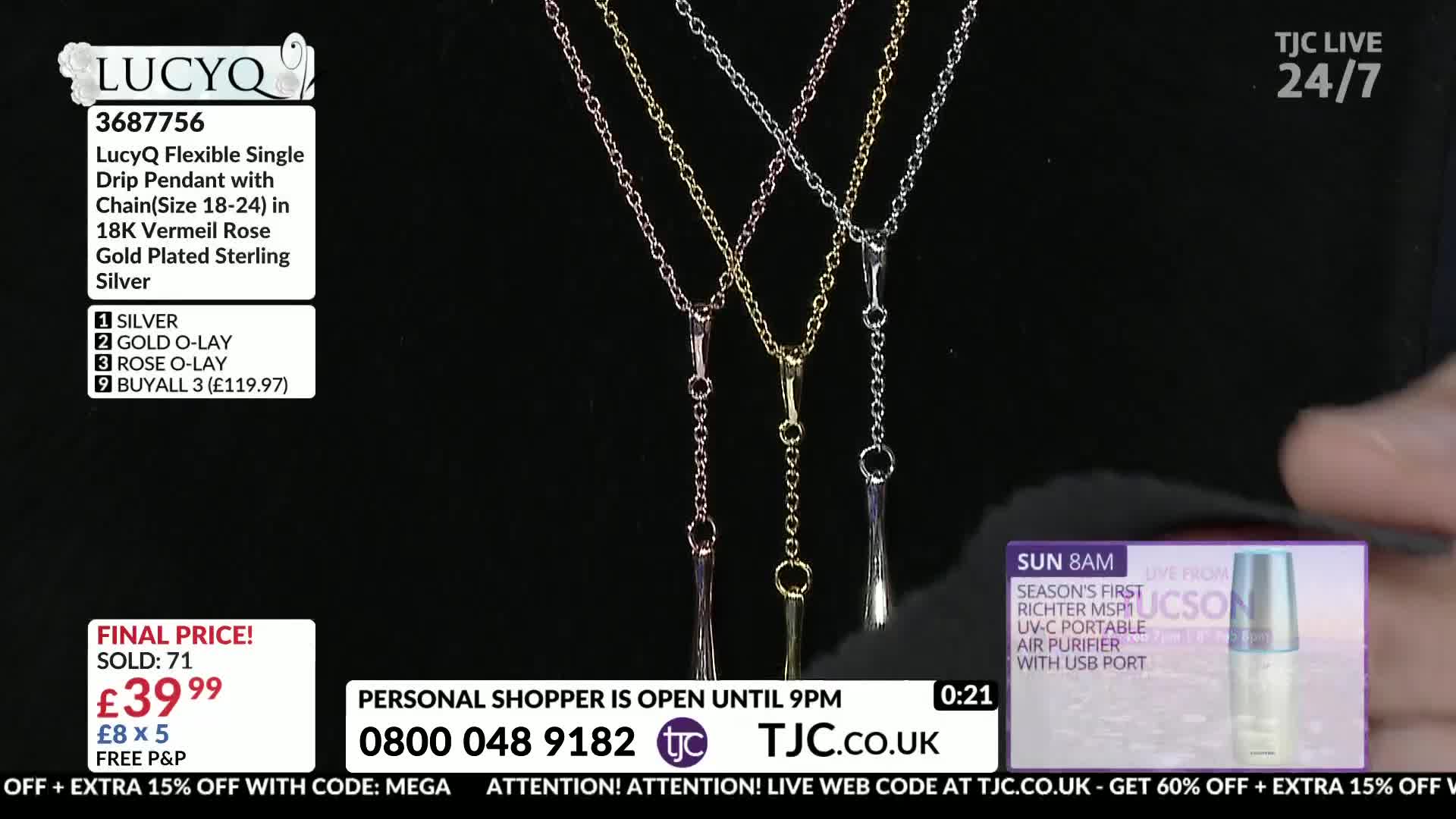 Three delicate necklaces hang against a black background, their chains a mix of silver, gold, and rose gold. A hand, partially visible, adjusts the position of the rose gold pendant on the right.