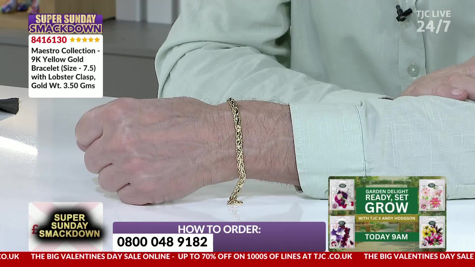 A man's wrist is adorned with a gleaming 9ct yellow gold bracelet. The intricate links of the bracelet catch the light as his hand rests on a white surface.