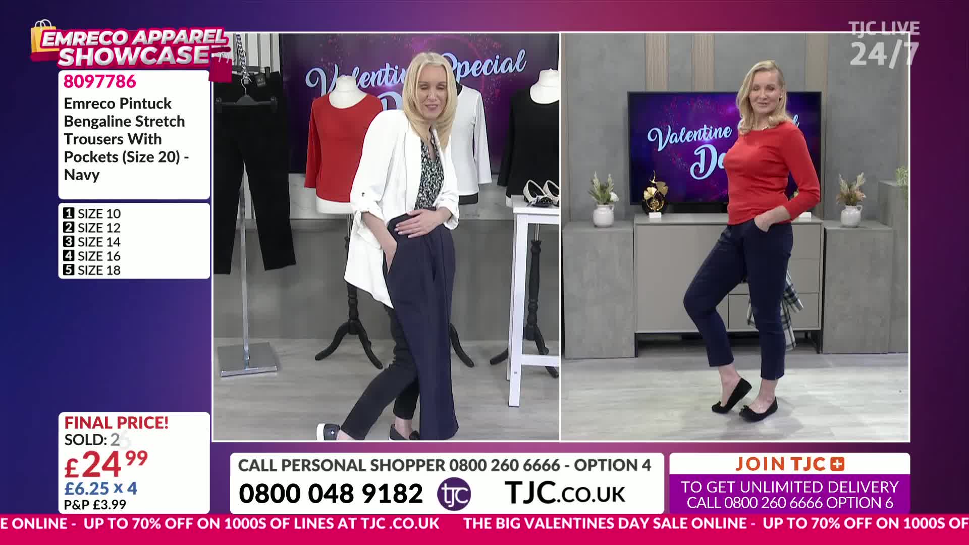 A woman in a white blazer and navy trousers walks across the stage, her hands tucked into her pockets. Another woman stands to the right, modelling the same navy trousers with a red top.