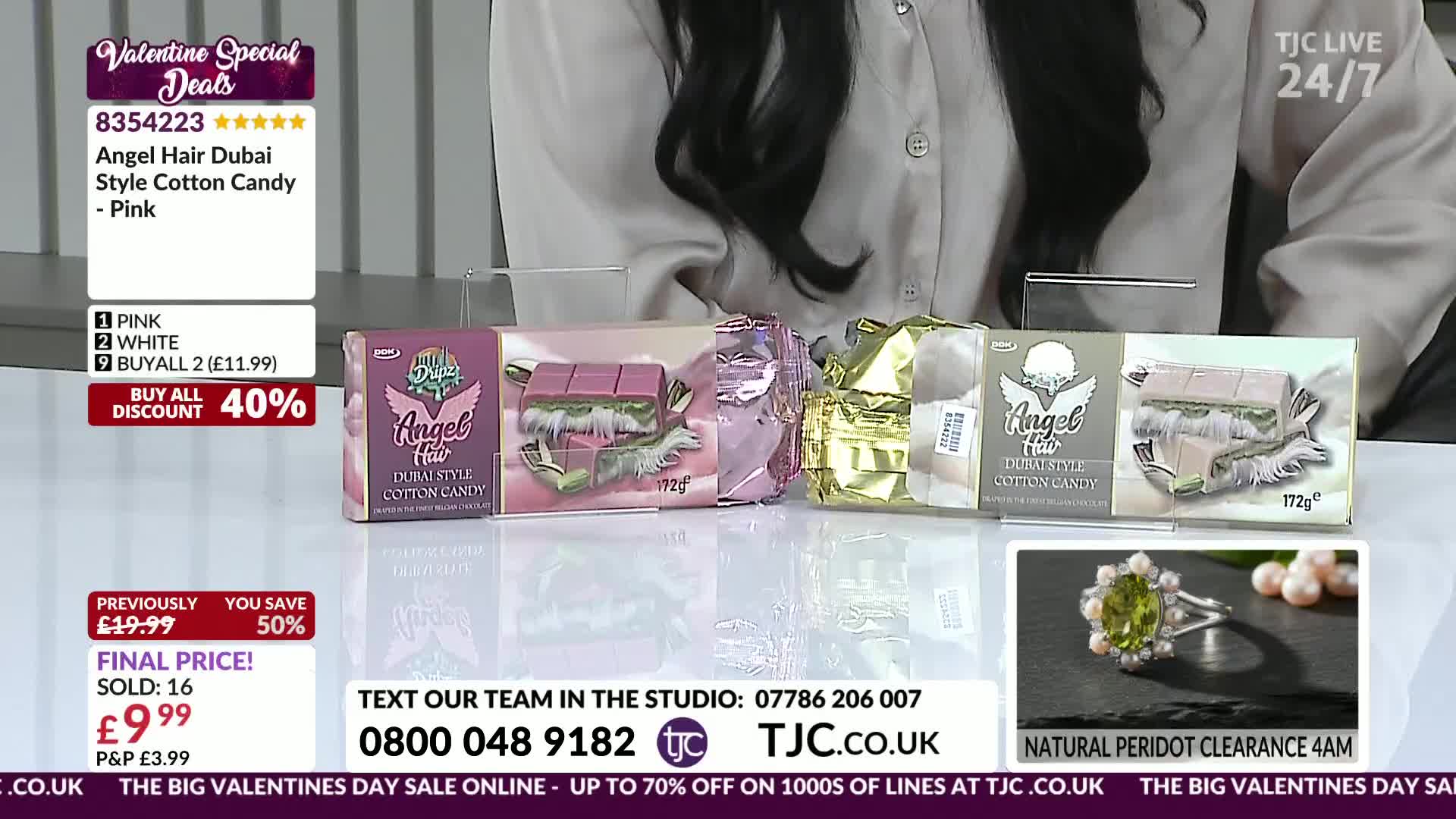 Four pastel-coloured boxes of Angel Hair Dubai Style Cotton Candy are lined up on a white surface. A ring with a green stone and pearls is displayed in a smaller frame below.