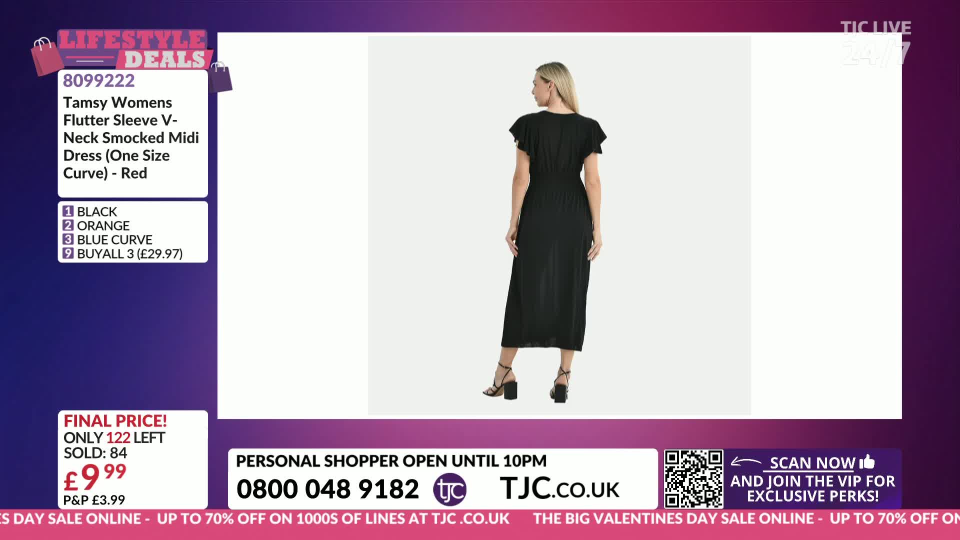 A woman stands in a black midi dress with flutter sleeves. The dress is shown from the back, highlighting its smocked waist and pleated skirt.