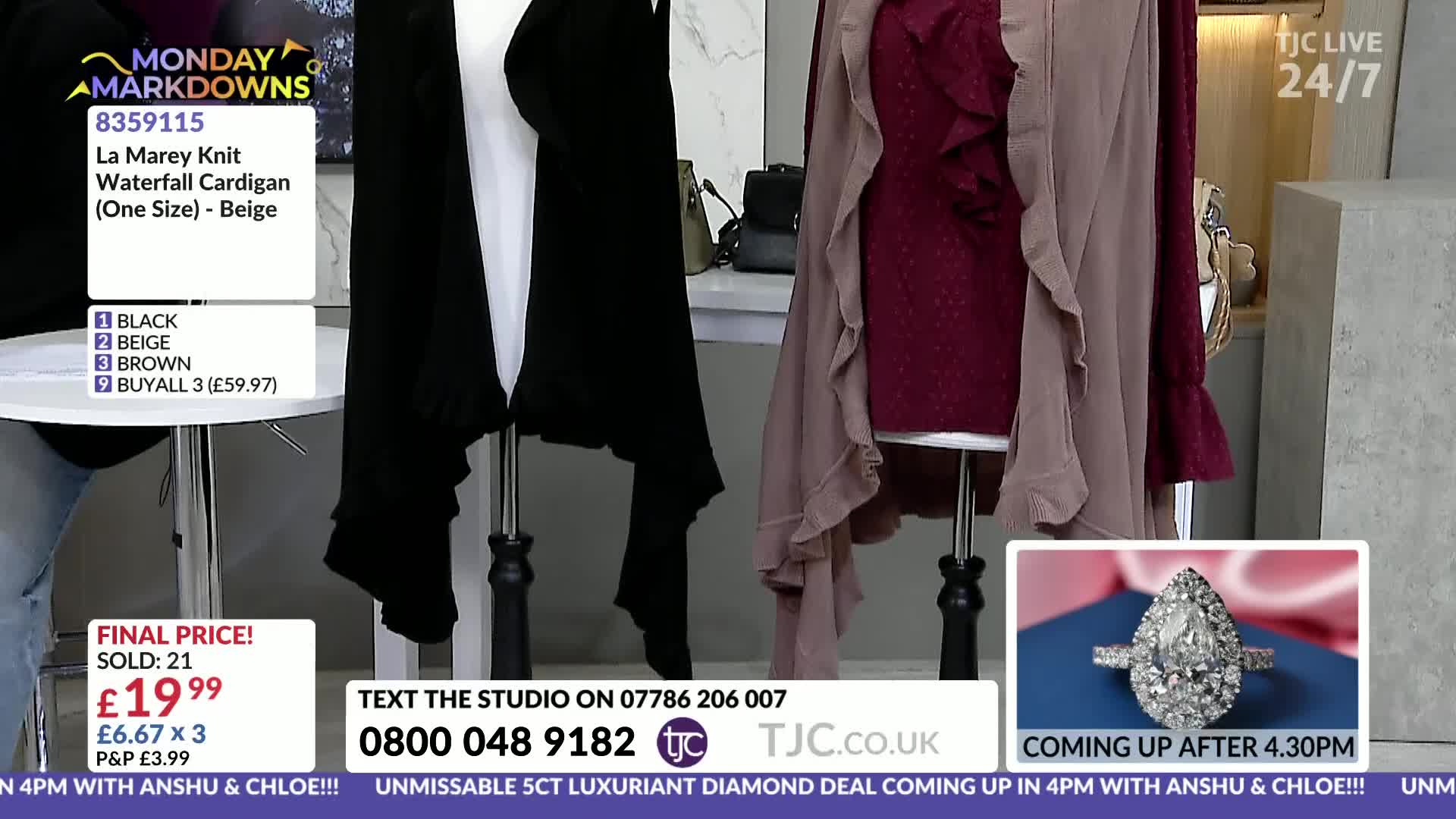A black waterfall cardigan drapes over a mannequin, and next to it, a burgundy top is layered with a dusty rose cardigan. A large pear-shaped diamond ring is displayed in a small box, promising a luxurious deal.