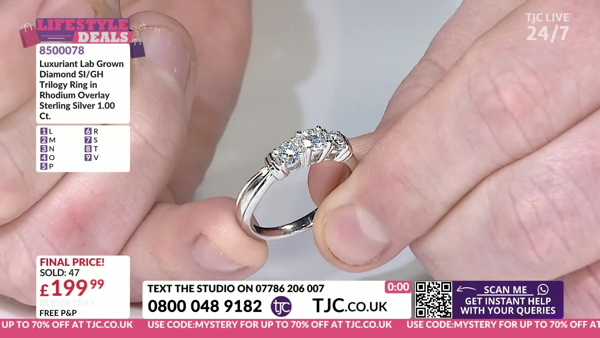 Fingers turn a silver ring, showing off three sparkling diamonds. The TJC logo is visible on screen, alongside details of the ring and its price.