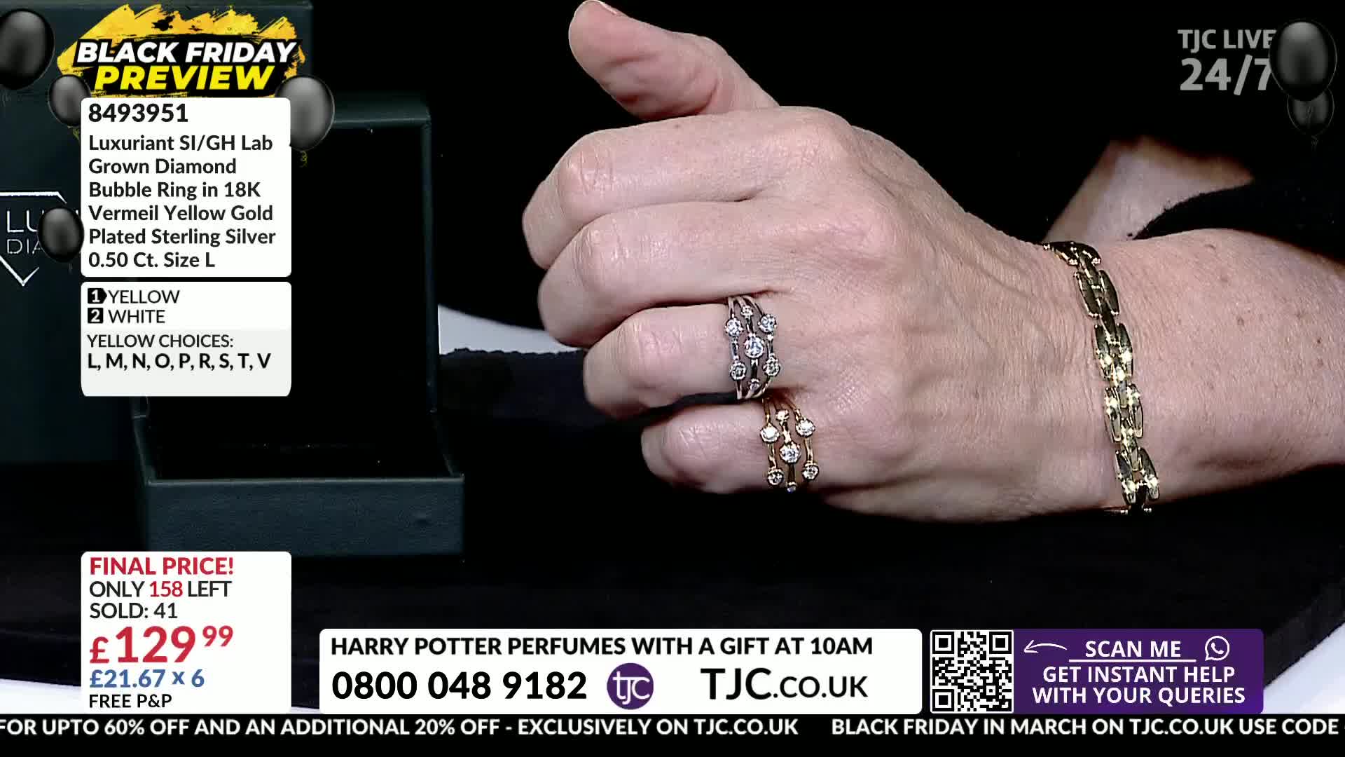 A hand displays two rings, one silver and one gold, each set with small, sparkling stones. A chunky gold bracelet adorns the wrist, catching the light.