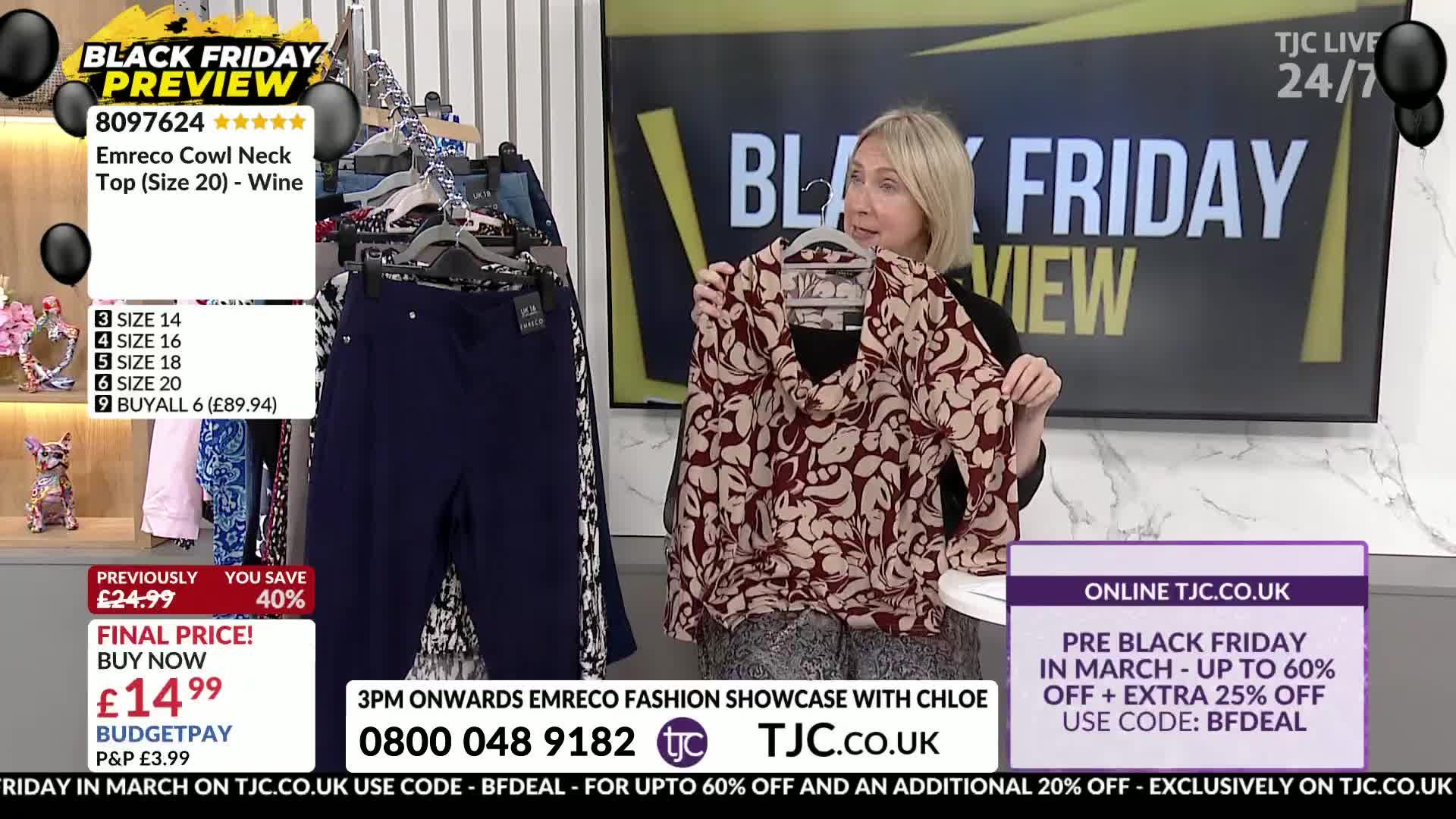 A woman on TJC holds up a patterned blouse. Nearby, a rack displays navy trousers and other garments.